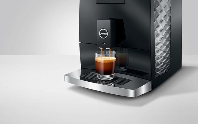 koffieuitloop van de C3 koffiemachine waar koffie uit stroomt in een glas